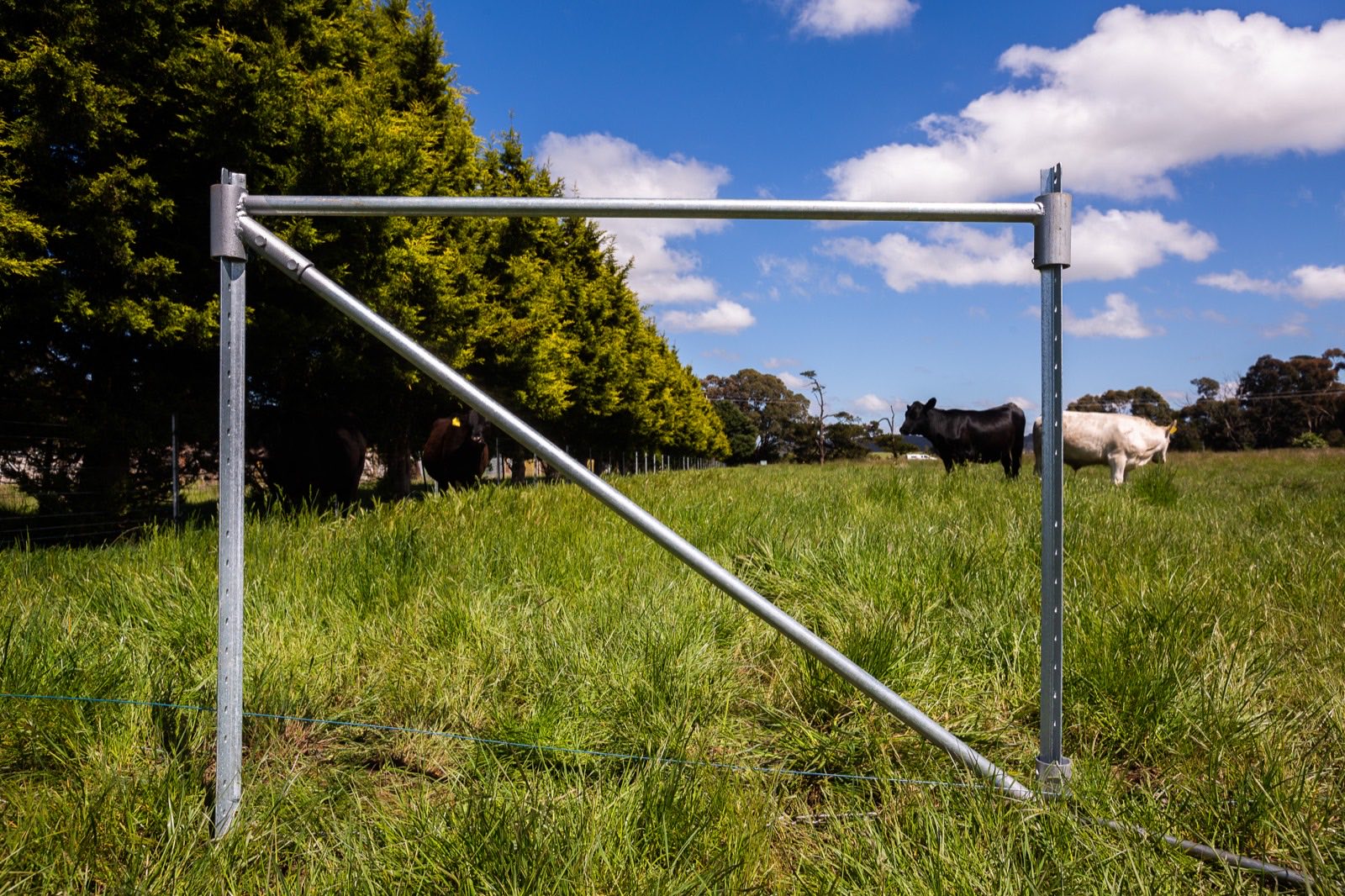 Installed FenceStay galvanised steel end assembly in a paddock under blue sky