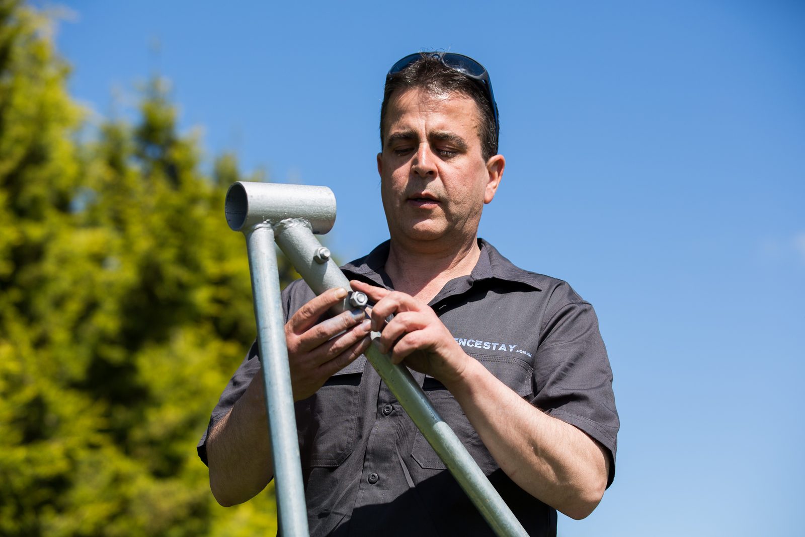 Driving a star picket into the ground with a post driver